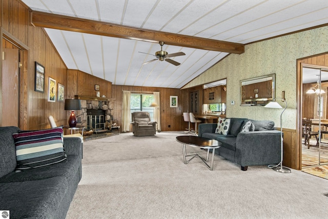 14501 Williams Dr, Elk Rapids, MI 49629 - carpeted living room featuring wooden walls, a ceiling fan, and a stone fireplace