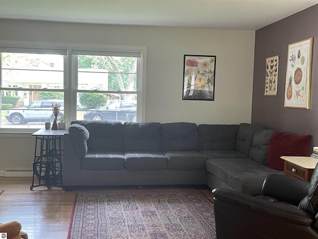 906 Vassar St, Alma, MI 48801 - living area featuring wood finished floors and a baseboard radiator