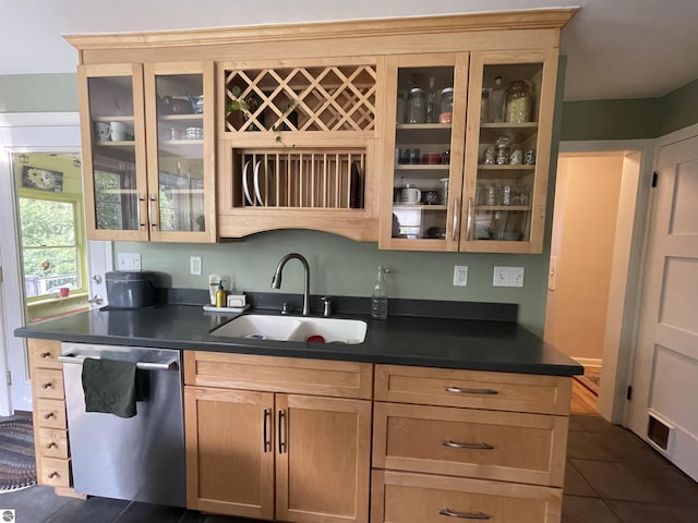 906 Vassar St, Alma, MI 48801 - kitchen featuring dishwasher, a sink, dark tile patterned flooring, and dark countertops