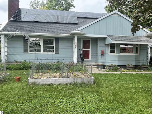906 Vassar St, Alma, MI 48801 - bungalow-style home with a chimney, a garden, a front lawn, and roof with shingles