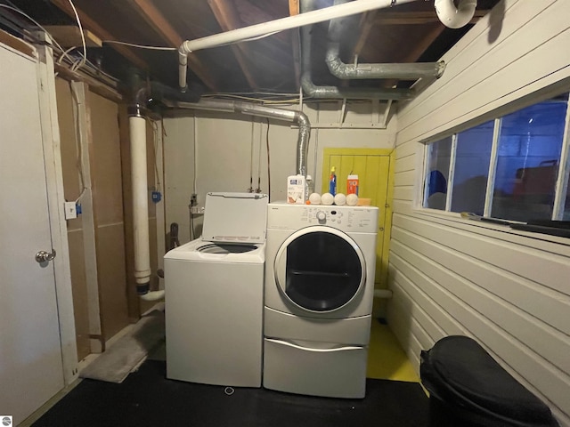 906 Vassar St, Alma, MI 48801 - laundry room featuring washing machine and clothes dryer and wood walls