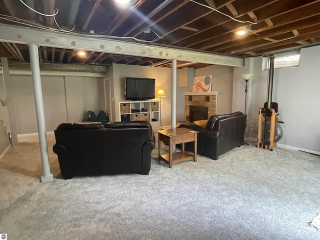 906 Vassar St, Alma, MI 48801 - carpeted living room featuring a fireplace and baseboards