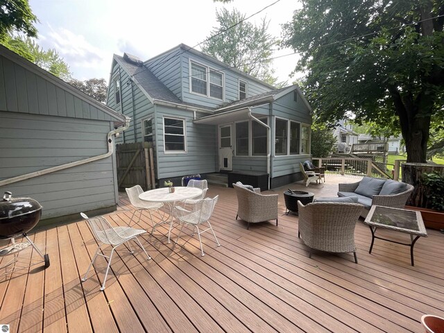906 Vassar St, Alma, MI 48801 - wooden deck featuring an outdoor living space with a fire pit