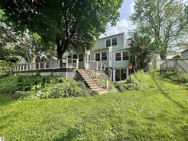 906 Vassar St, Alma, MI 48801 - rear view of house featuring a deck, stairs, and a sunroom