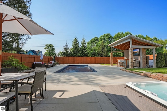 710 E Division St, Cadillac, MI 49601 - view of pool with an outdoor hot tub, a fenced backyard, a patio area, and outdoor dining area