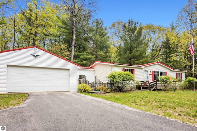 11748 NE Franklin St, Kalkaska, MI 49646 - manufactured / mobile home featuring an outdoor structure and asphalt driveway