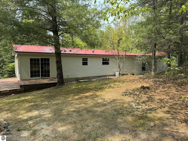 11748 NE Franklin St, Kalkaska, MI 49646 - back of house featuring a wooden deck and metal roof