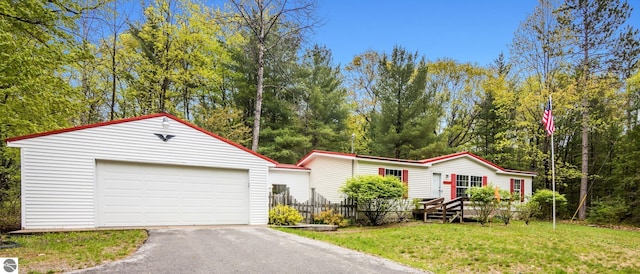 11748 NE Franklin St, Kalkaska, MI 49646 - manufactured / mobile home with an outbuilding, asphalt driveway, and a detached garage