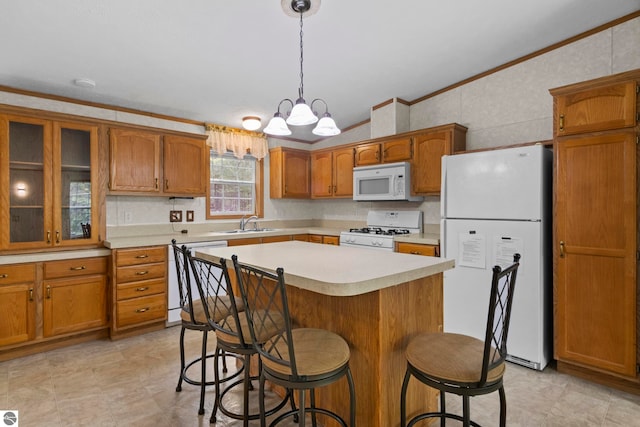 11748 NE Franklin St, Kalkaska, MI 49646 - kitchen featuring white appliances, brown cabinetry, a sink, light countertops, and a kitchen bar