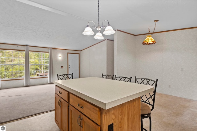 11748 NE Franklin St, Kalkaska, MI 49646 - kitchen featuring crown molding, a breakfast bar area, a center island, brown cabinets, and hanging light fixtures