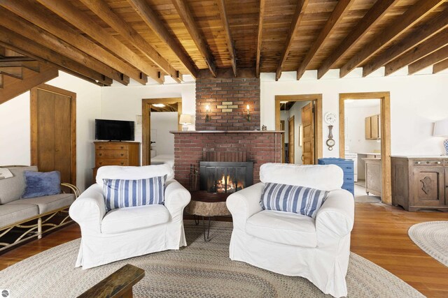 1884 Beech Rd, Frankfort, MI 49635 - living area with wood finished floors, a fireplace, and wooden ceiling with exposed beams