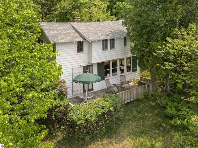 1884 Beech Rd, Frankfort, MI 49635 - rear view of house featuring roof with shingles, a wooden deck, and a chimney
