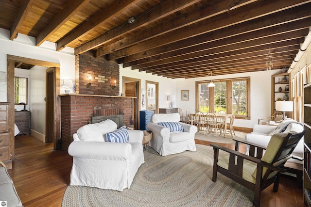 1884 Beech Rd, Frankfort, MI 49635 - living room with wood-type flooring, plenty of natural light, a fireplace, baseboards, and wooden ceiling with exposed beams