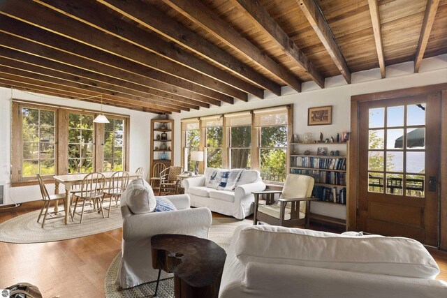 1884 Beech Rd, Frankfort, MI 49635 - living room with healthy amount of natural light, wood finished floors, and wooden ceiling with exposed beams