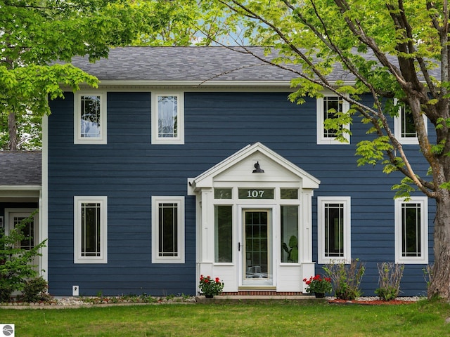107 Hillcrest Ct, Traverse City, MI 49684 - colonial house with a front yard and roof with shingles