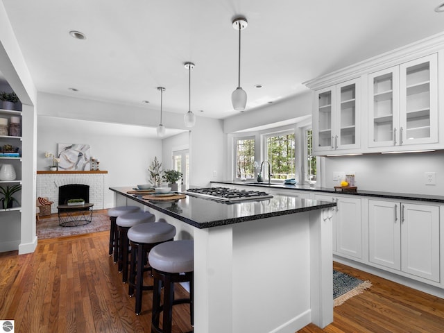 107 Hillcrest Ct, Traverse City, MI 49684 - kitchen with a sink, dark wood-type flooring, white cabinetry, a kitchen breakfast bar, and recessed lighting