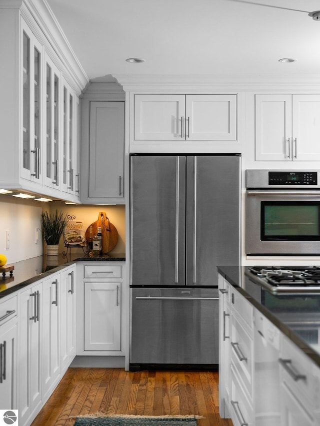 107 Hillcrest Ct, Traverse City, MI 49684 - kitchen featuring stainless steel appliances, white cabinets, ornamental molding, and recessed lighting