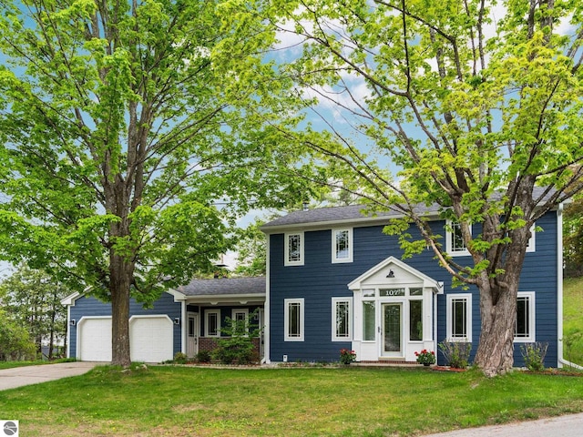 107 Hillcrest Ct, Traverse City, MI 49684 - colonial-style house with concrete driveway, a front yard, and an attached garage
