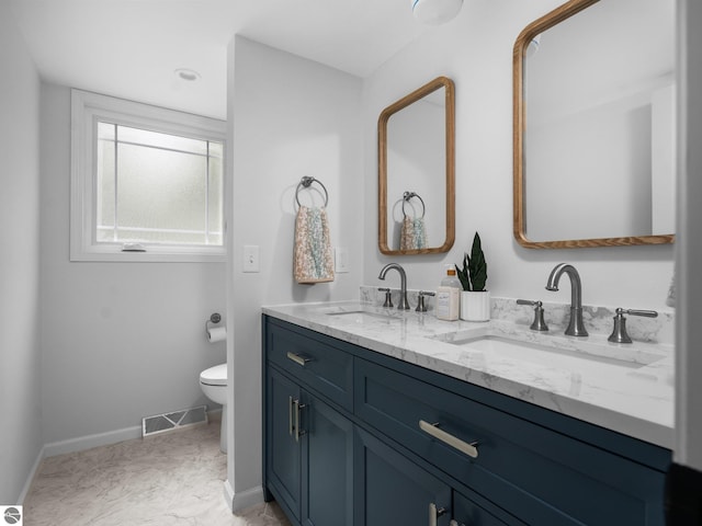 107 Hillcrest Ct, Traverse City, MI 49684 - full bathroom with double vanity, toilet, and baseboards