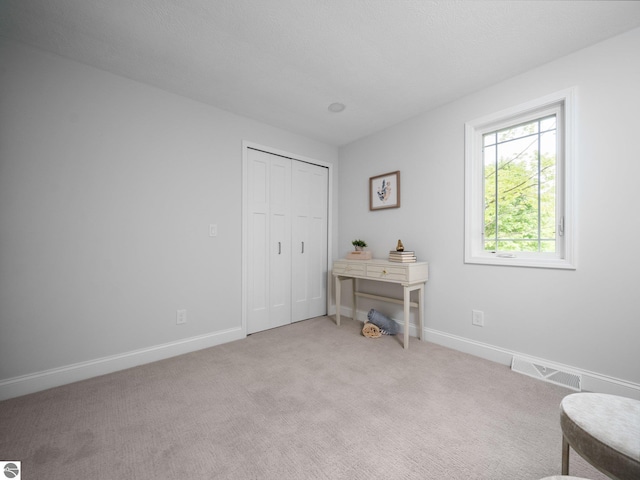 107 Hillcrest Ct, Traverse City, MI 49684 - sitting room with light carpet and baseboards