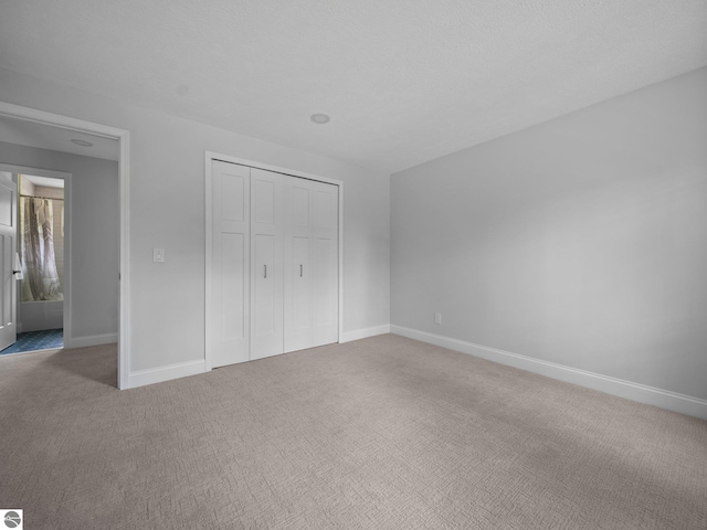 107 Hillcrest Ct, Traverse City, MI 49684 - unfurnished bedroom featuring carpet floors, baseboards, and a closet