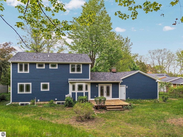 107 Hillcrest Ct, Traverse City, MI 49684 - rear view of property with a deck, french doors, a chimney, a yard, and roof with shingles