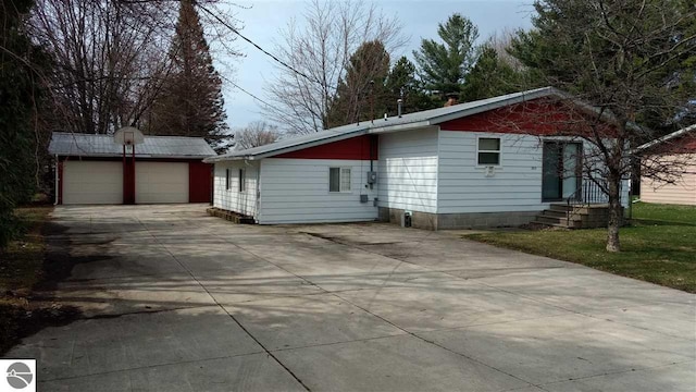 205 Fannie St, Au Gres, MI 48703 - view of home's exterior with an outbuilding and a garage