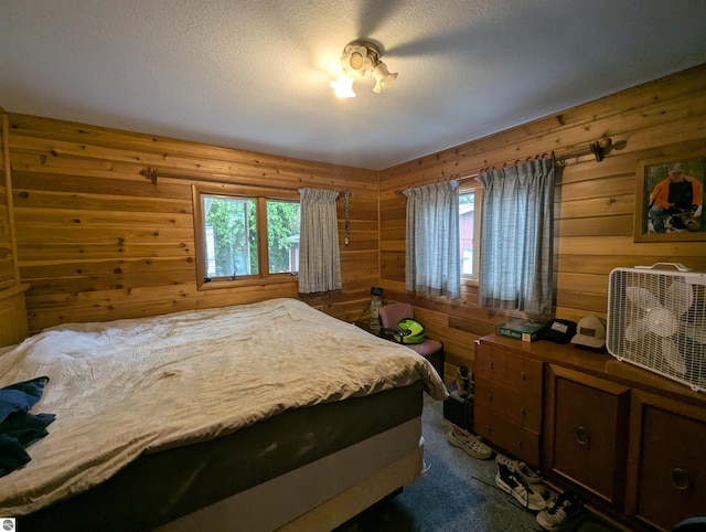 205 Fannie St, Au Gres, MI 48703 - bedroom featuring wood walls, dark carpet, and a textured ceiling