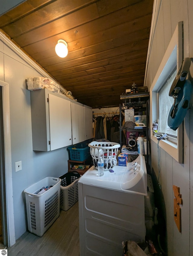 205 Fannie St, Au Gres, MI 48703 - washroom featuring wood ceiling, wood finished floors, washer / dryer, and cabinet space