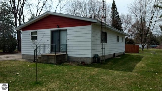 205 Fannie St, Au Gres, MI 48703 - view of property exterior with a lawn