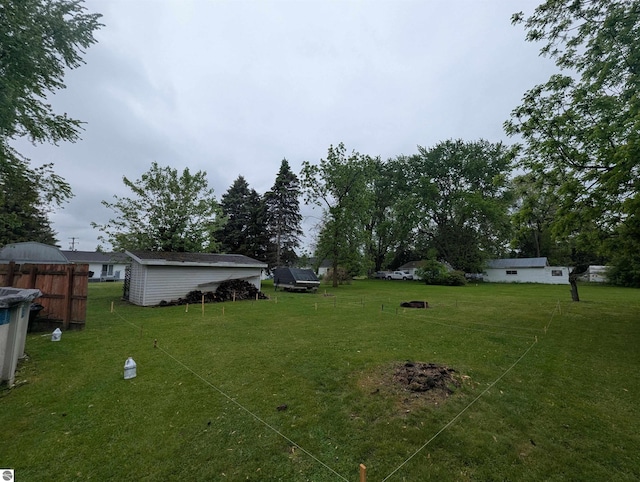 205 Fannie St, Au Gres, MI 48703 - view of green lawn featuring an outdoor structure