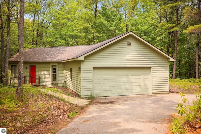 1631 Melody Ln, Interlochen, MI 49643 - view of front of property with driveway and roof with shingles