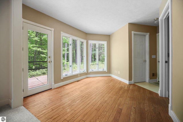 1631 Melody Ln, Interlochen, MI 49643 - unfurnished room with baseboards and hardwood / wood-style flooring