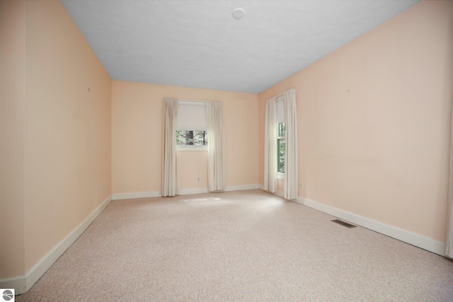 1631 Melody Ln, Interlochen, MI 49643 - empty room featuring light carpet and baseboards