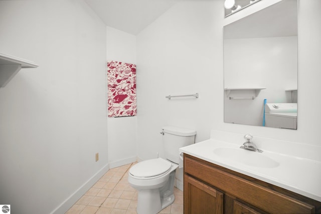 1631 Melody Ln, Interlochen, MI 49643 - bathroom with vanity, toilet, washer / clothes dryer, tile patterned flooring, and baseboards