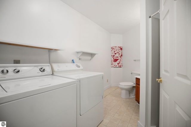 1631 Melody Ln, Interlochen, MI 49643 - laundry room featuring washing machine and dryer, light tile patterned floors, and baseboards