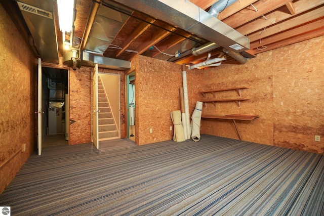 1631 Melody Ln, Interlochen, MI 49643 - unfinished basement with carpet and stairs