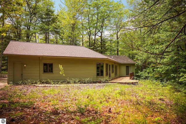 1631 Melody Ln, Interlochen, MI 49643 - rear view of property with a shingled roof and a wooden deck