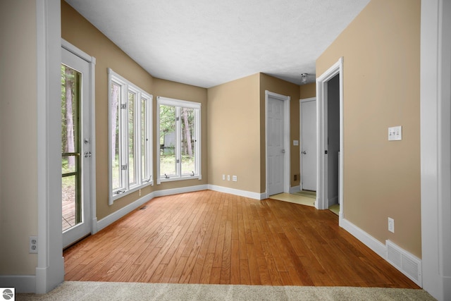 1631 Melody Ln, Interlochen, MI 49643 - empty room featuring baseboards and hardwood / wood-style flooring