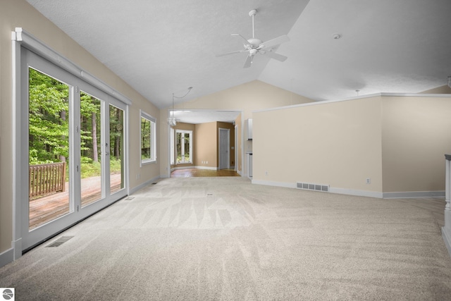 1631 Melody Ln, Interlochen, MI 49643 - unfurnished room with light colored carpet, ceiling fan, baseboards, and lofted ceiling