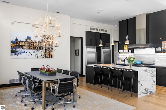 9371 Onominese Trl, Northport, MI 49670 - dining area with light wood finished floors and a chandelier