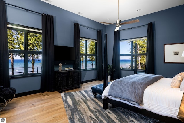 9371 Onominese Trl, Northport, MI 49670 - bedroom with multiple windows, light wood-type flooring, and recessed lighting