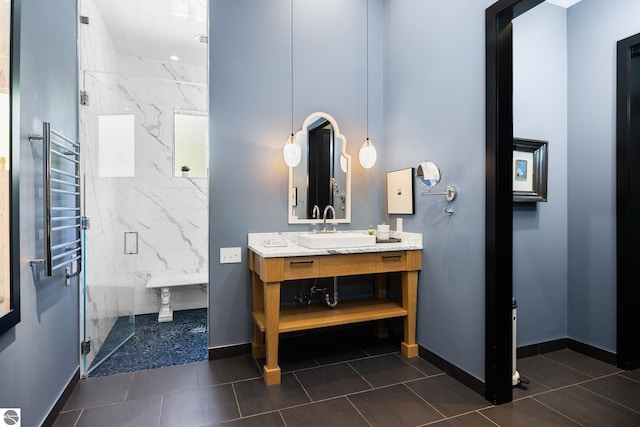 9371 Onominese Trl, Northport, MI 49670 - full bath with a marble finish shower, vanity, a towel warming rack, baseboards, and tile patterned floors