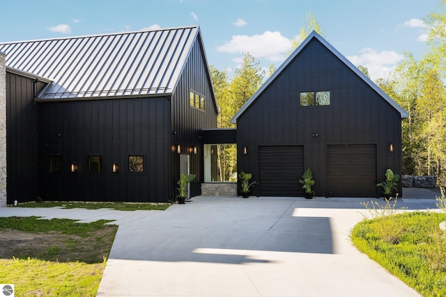 9371 Onominese Trl, Northport, MI 49670 - modern farmhouse featuring driveway, a standing seam roof, metal roof, and board and batten siding