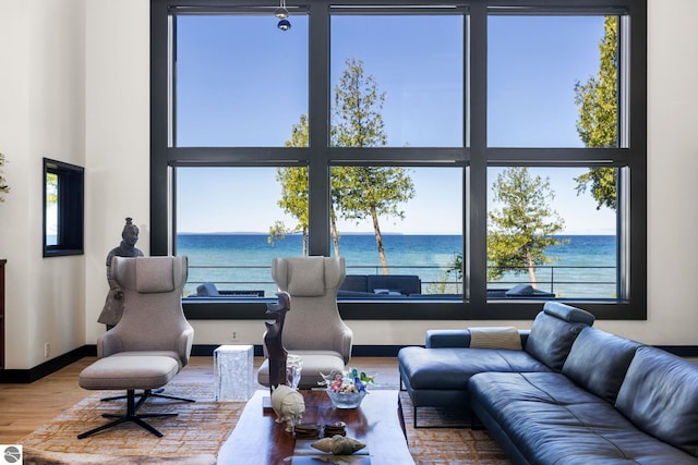 9371 Onominese Trl, Northport, MI 49670 - living room featuring a water view, wood finished floors, and baseboards