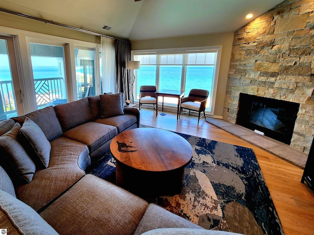 5707 S Lake St Unit 13F, Glen Arbor, MI 49636 - living area with lofted ceiling, healthy amount of natural light, wood finished floors, and a fireplace