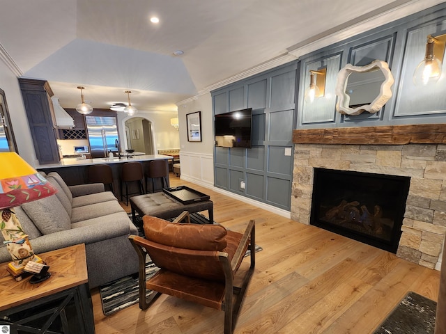 5707 S Lake St Unit 13F, Glen Arbor, MI 49636 - living area featuring a decorative wall, arched walkways, light wood-style flooring, lofted ceiling, and crown molding