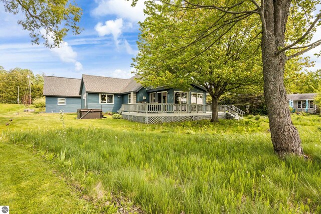 3802 S Grants Lndg, Lake Leelanau, MI 49653 - view of front of house featuring a deck and a shingled roof