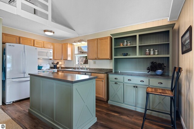 3802 S Grants Lndg, Lake Leelanau, MI 49653 - kitchen with white appliances, dark countertops, a kitchen island, a sink, and dark wood finished floors
