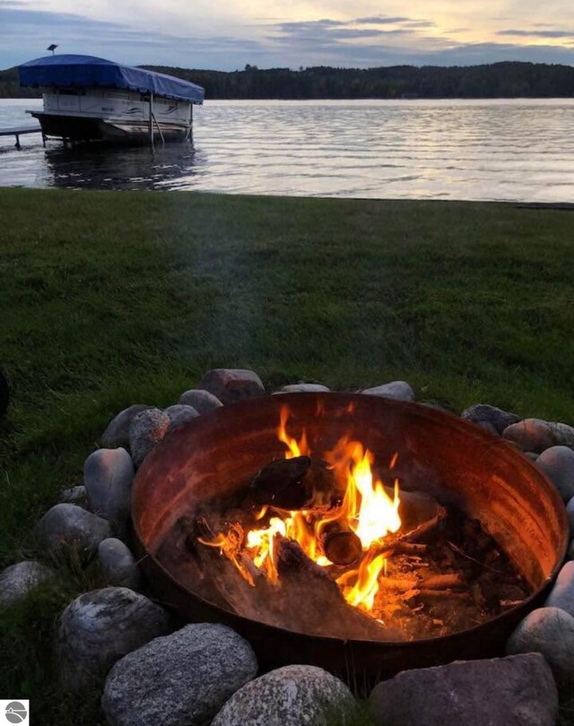 3802 S Grants Lndg, Lake Leelanau, MI 49653 - dock featuring an outdoor fire pit and a water view